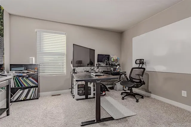 a view of a livingroom with furniture and a flat screen tv