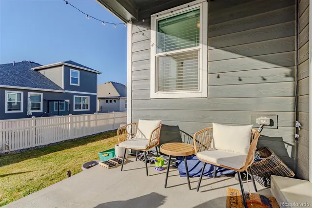 a swimming pool with some potted plants and large tree