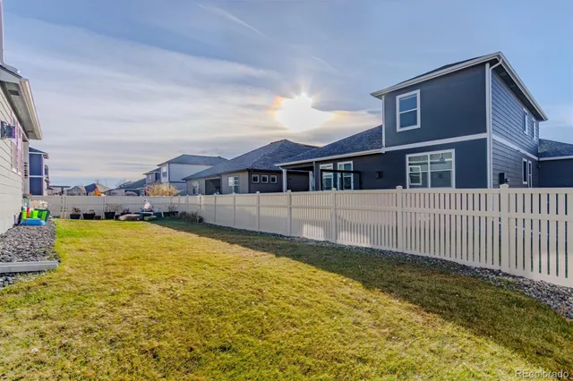 a view of a house with a yard and sitting area