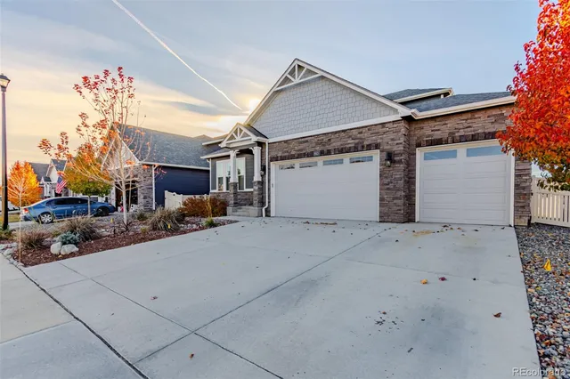 a view of a hallway with wooden floor and a bathroom