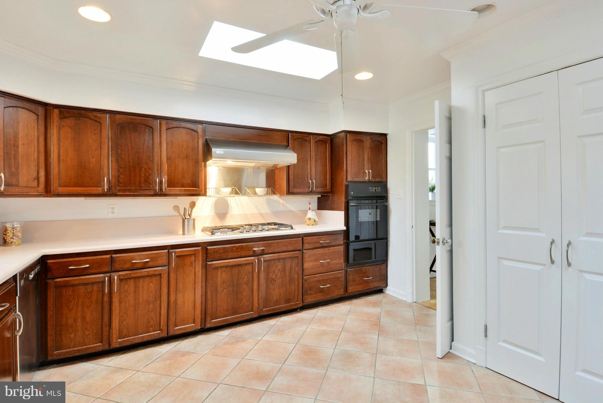 10021 Raynor Road Silver Spring, MD 20901 - Photo 12 of 30 a large kitchen with stainless steel appliances granite countertop a refrigerator and a sink