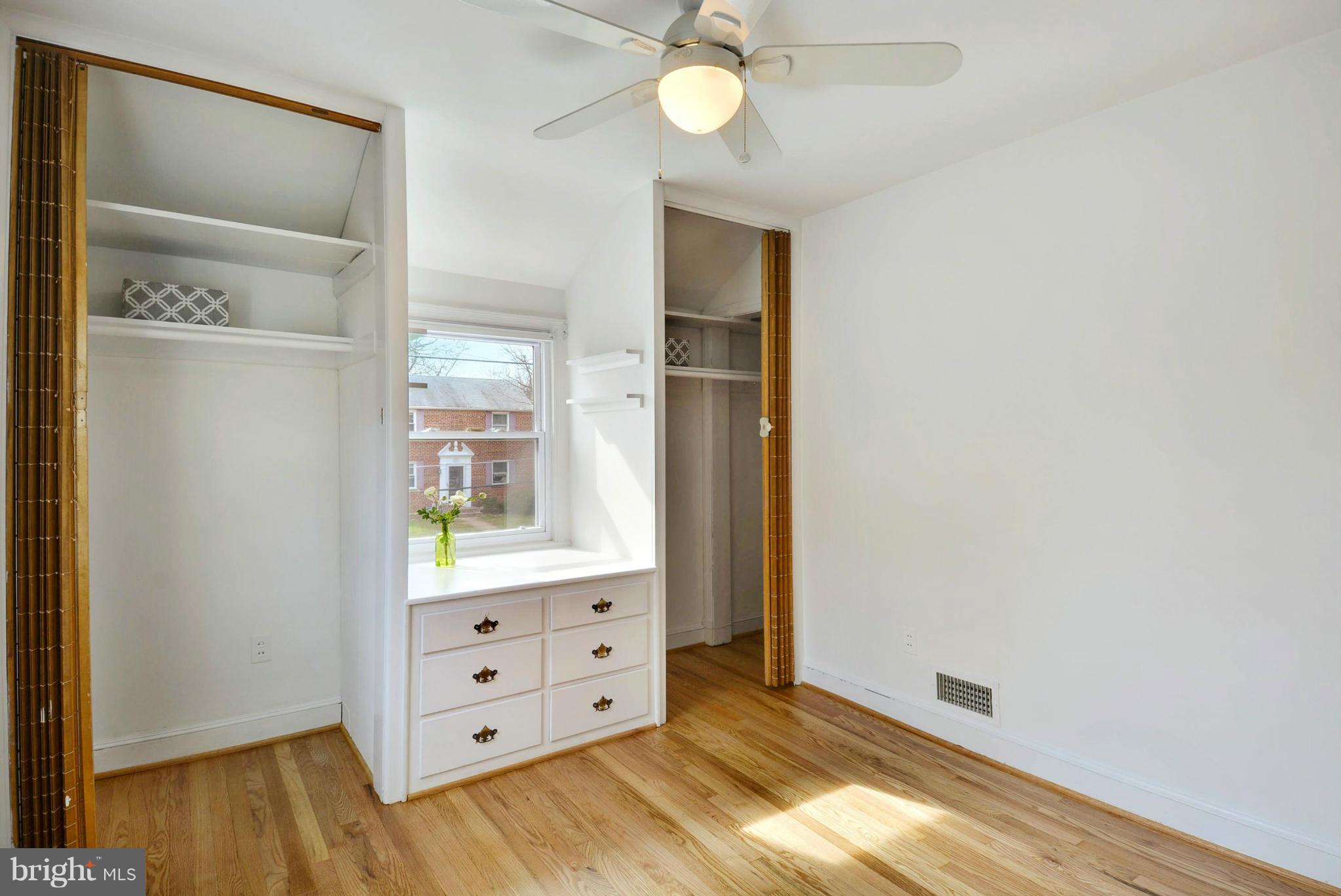 10021 Raynor Road Silver Spring, MD 20901 - Photo 16 of 30 an empty room with wooden floor cabinet and windows