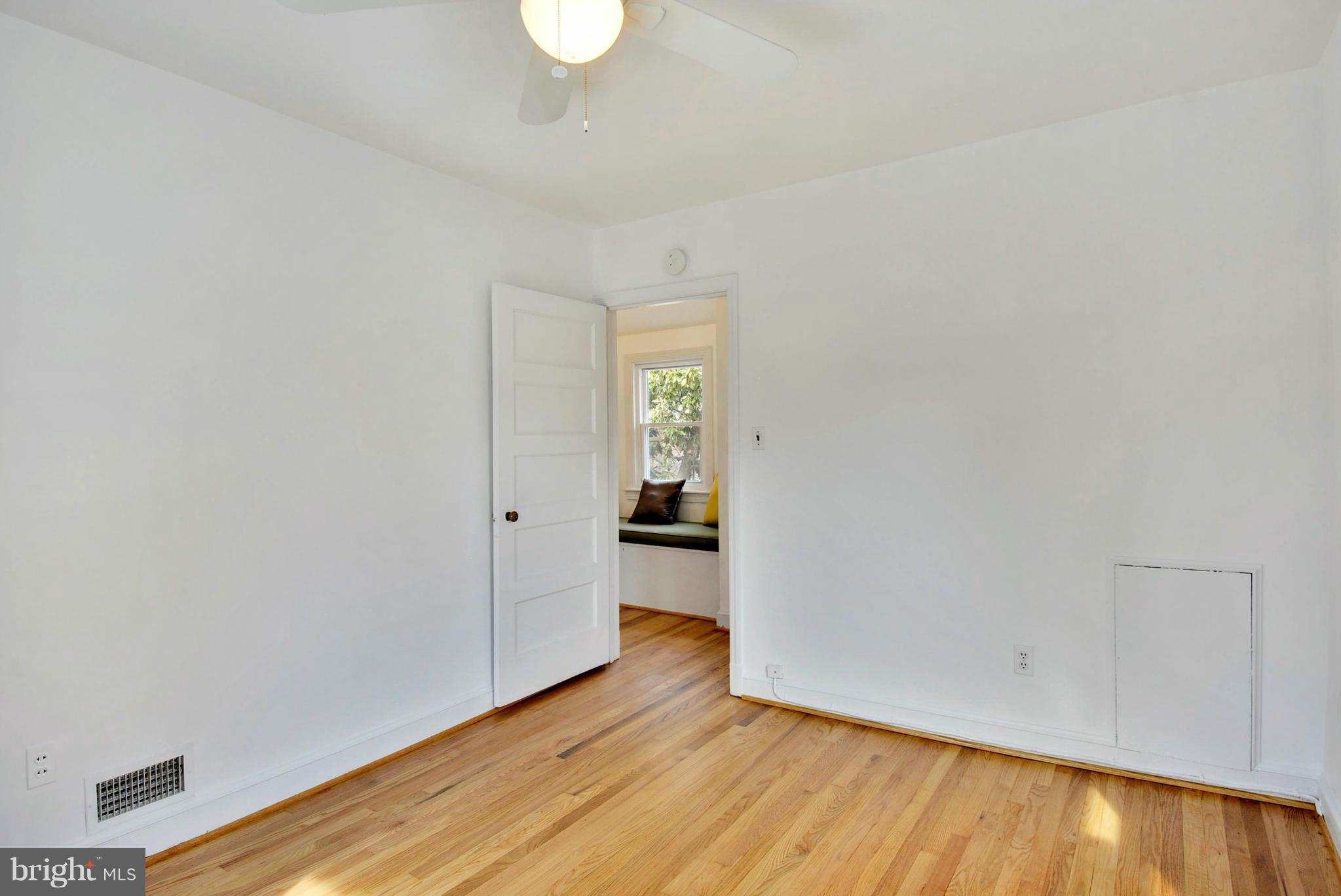 10021 Raynor Road Silver Spring, MD 20901 - Photo 17 of 30 a view of an empty room with wooden floor and a window