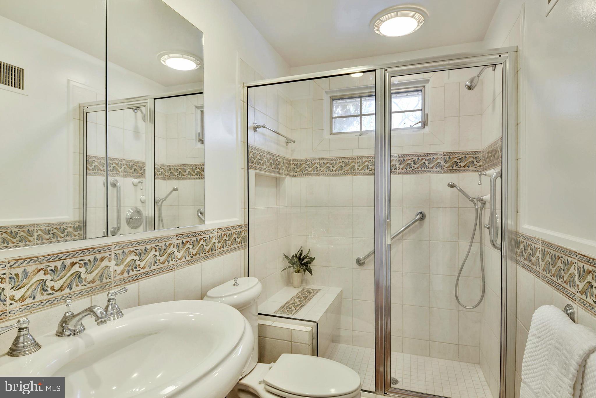 10021 Raynor Road Silver Spring, MD 20901 - Photo 20 of 30 a bathroom with a sink toilet and shower