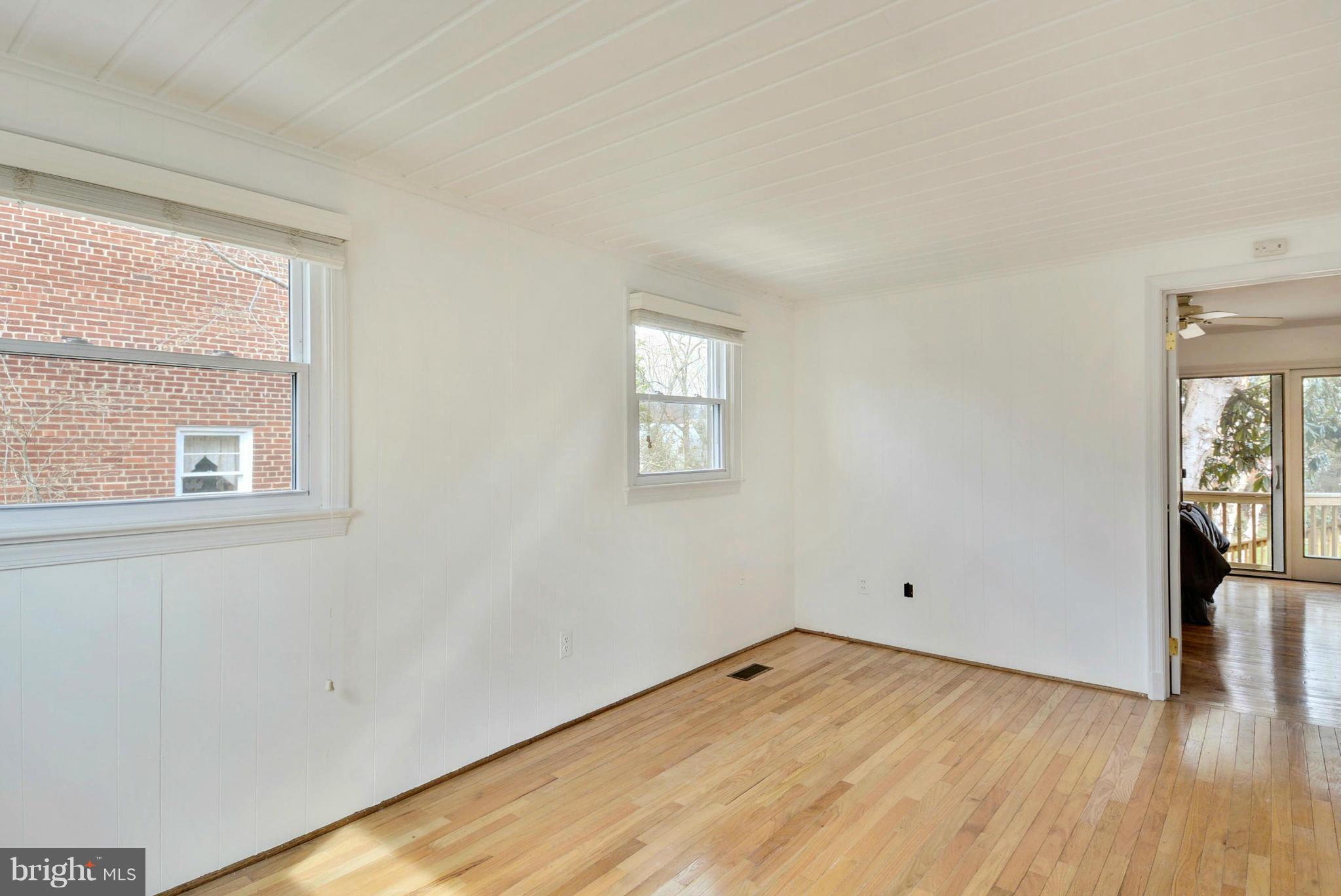 10021 Raynor Road Silver Spring, MD 20901 - Photo 23 of 30 an empty room with wooden floor and windows