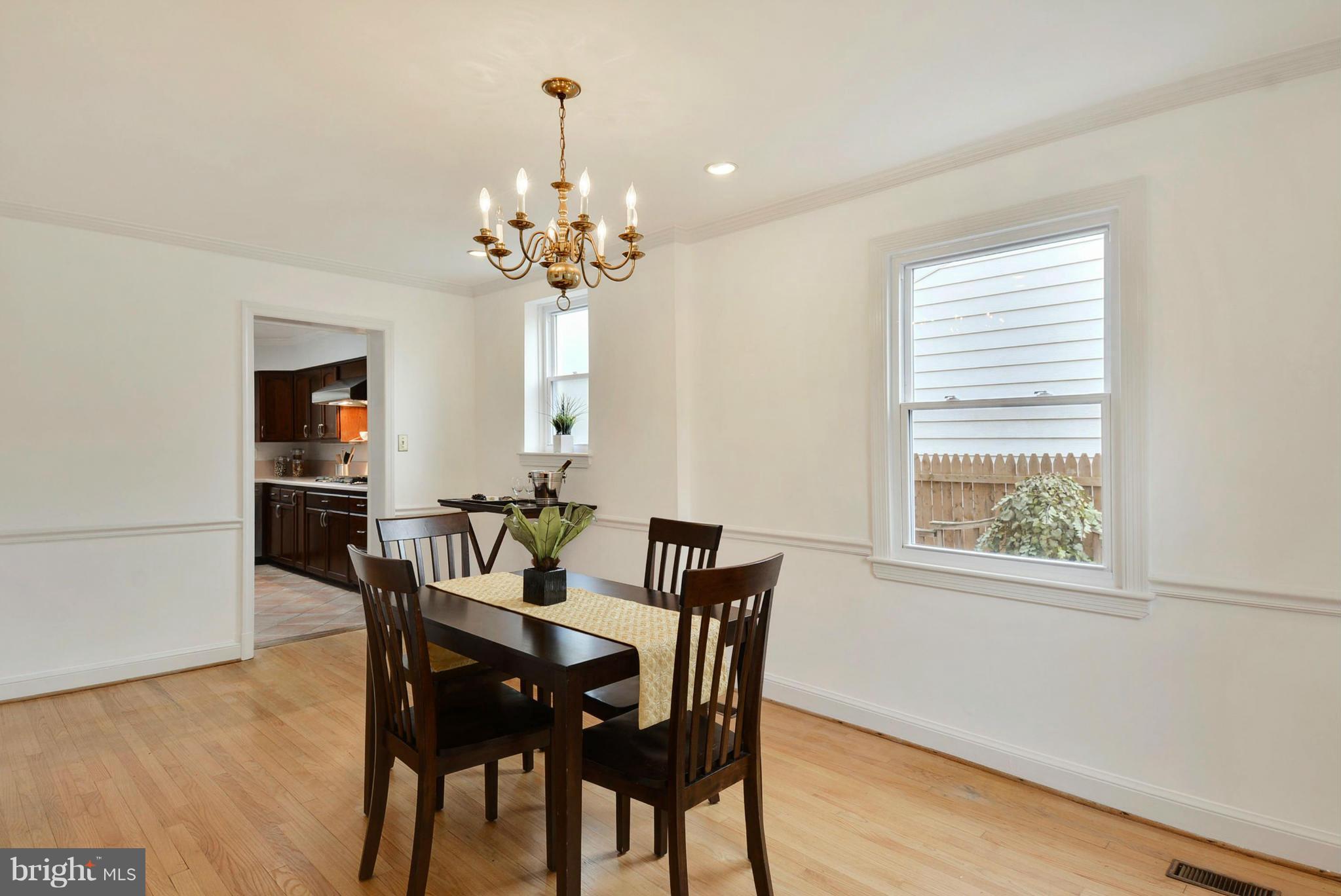10021 Raynor Road Silver Spring, MD 20901 - Photo 8 of 30 a view of a dining room with furniture window and wooden floor