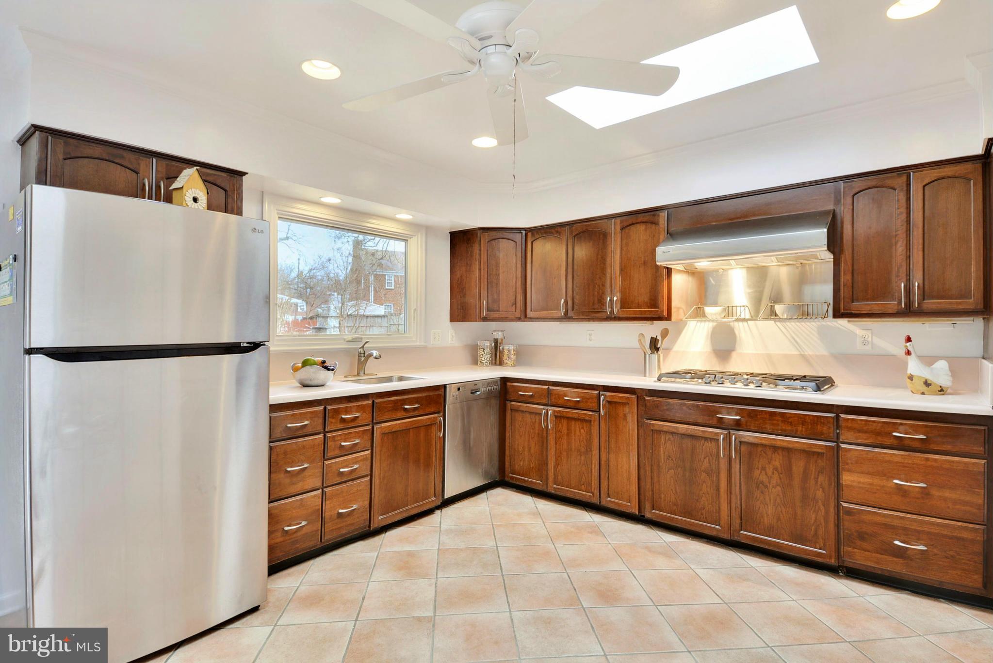 10021 Raynor Road Silver Spring, MD 20901 - Photo 10 of 30 a kitchen with stainless steel appliances granite countertop a refrigerator sink and cabinets