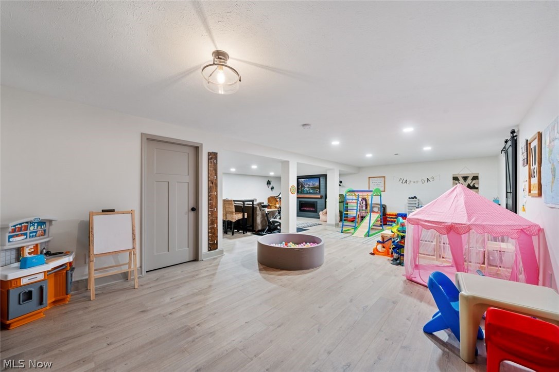 6517 Stone Road Medina, OH 44256 - Photo 32 of 47 Playroom with brick wall and light wood-type flooring