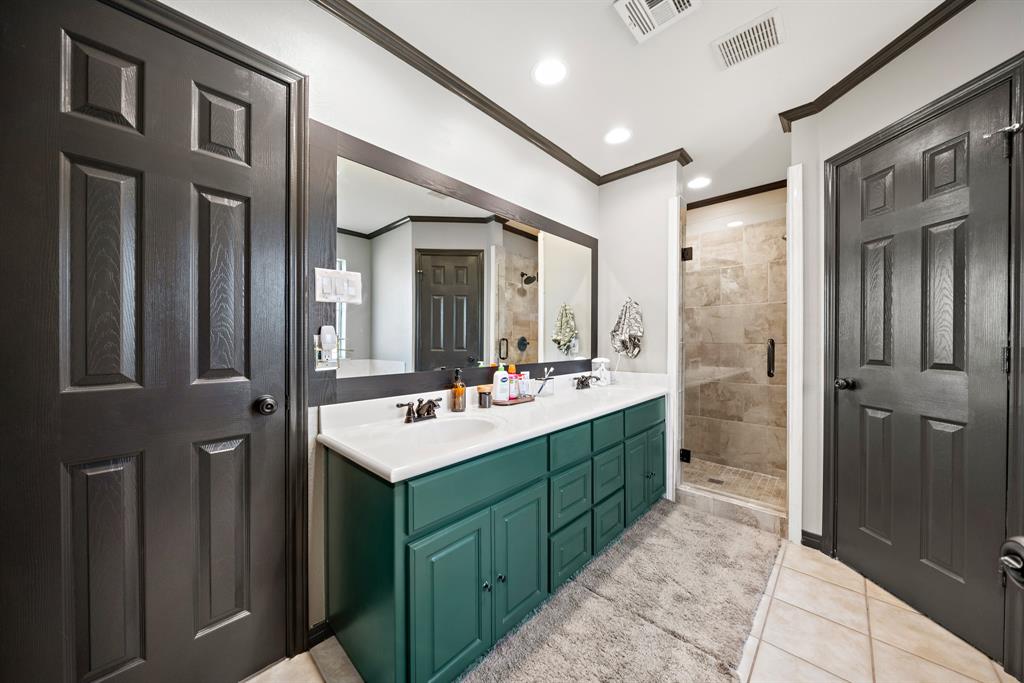 10512 Whitney Trace Drive Waco, TX 76708 - Photo 11 of 36 a bathroom with a sink mirror and shower