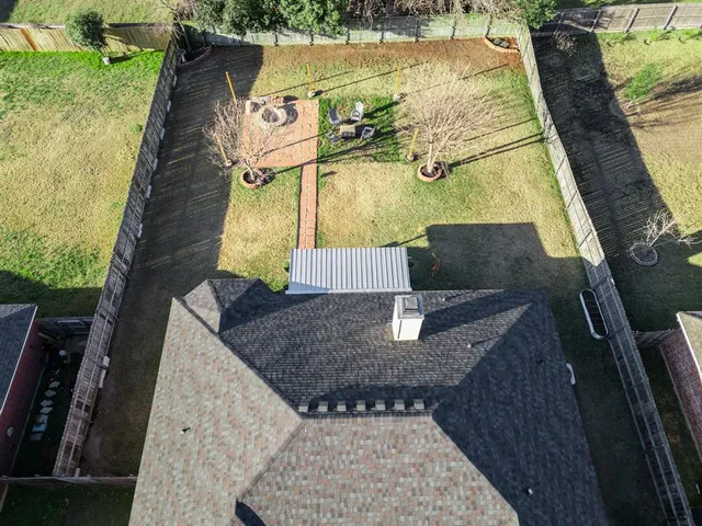 an aerial view of a house with outdoor space