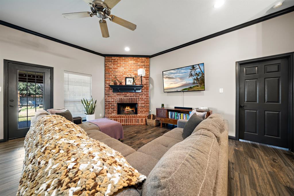 10512 Whitney Trace Drive Waco, TX 76708 - Photo 4 of 36 a living room with furniture a fireplace and a flat screen tv