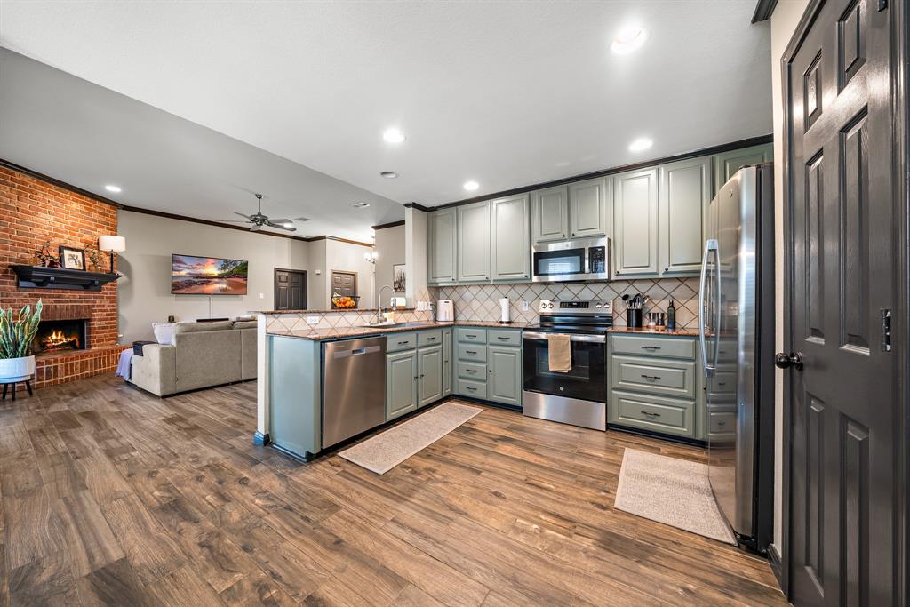 10512 Whitney Trace Drive Waco, TX 76708 - Photo 8 of 36 a kitchen with stainless steel appliances granite countertop a refrigerator and a stove top oven