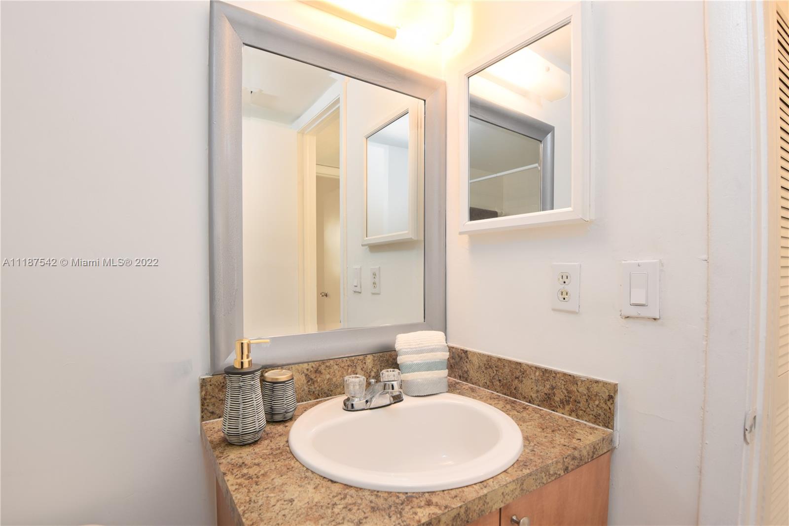 3199 Foxcroft Road, Unit 304 Miramar, FL 33025 - Photo 17 of 35 a bathroom with a sink and a mirror