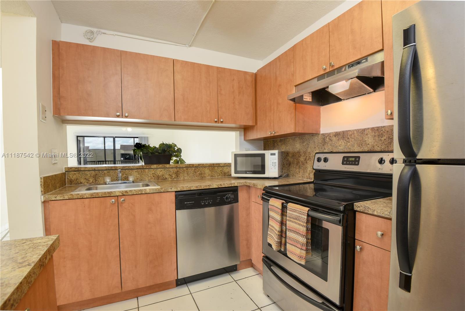 3199 Foxcroft Road, Unit 304 Miramar, FL 33025 - Photo 2 of 35 a kitchen with stainless steel appliances granite countertop a sink and a stove