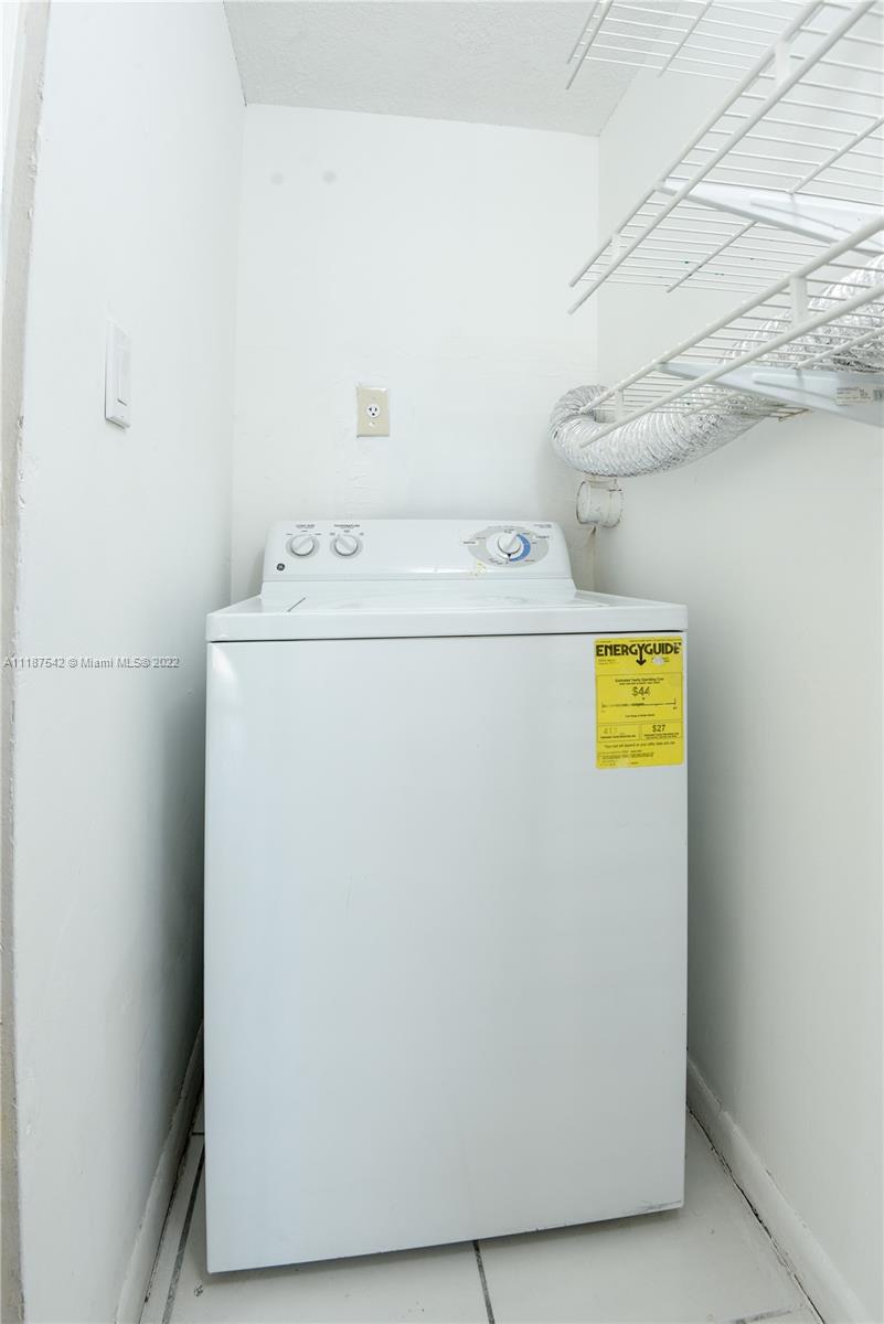 3199 Foxcroft Road, Unit 304 Miramar, FL 33025 - Photo 24 of 35 a utility room with dryer and washer