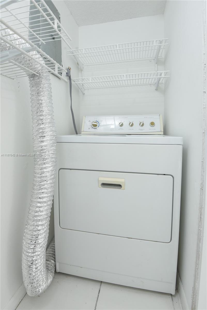 3199 Foxcroft Road, Unit 304 Miramar, FL 33025 - Photo 25 of 35 a utility room with dryer and washer