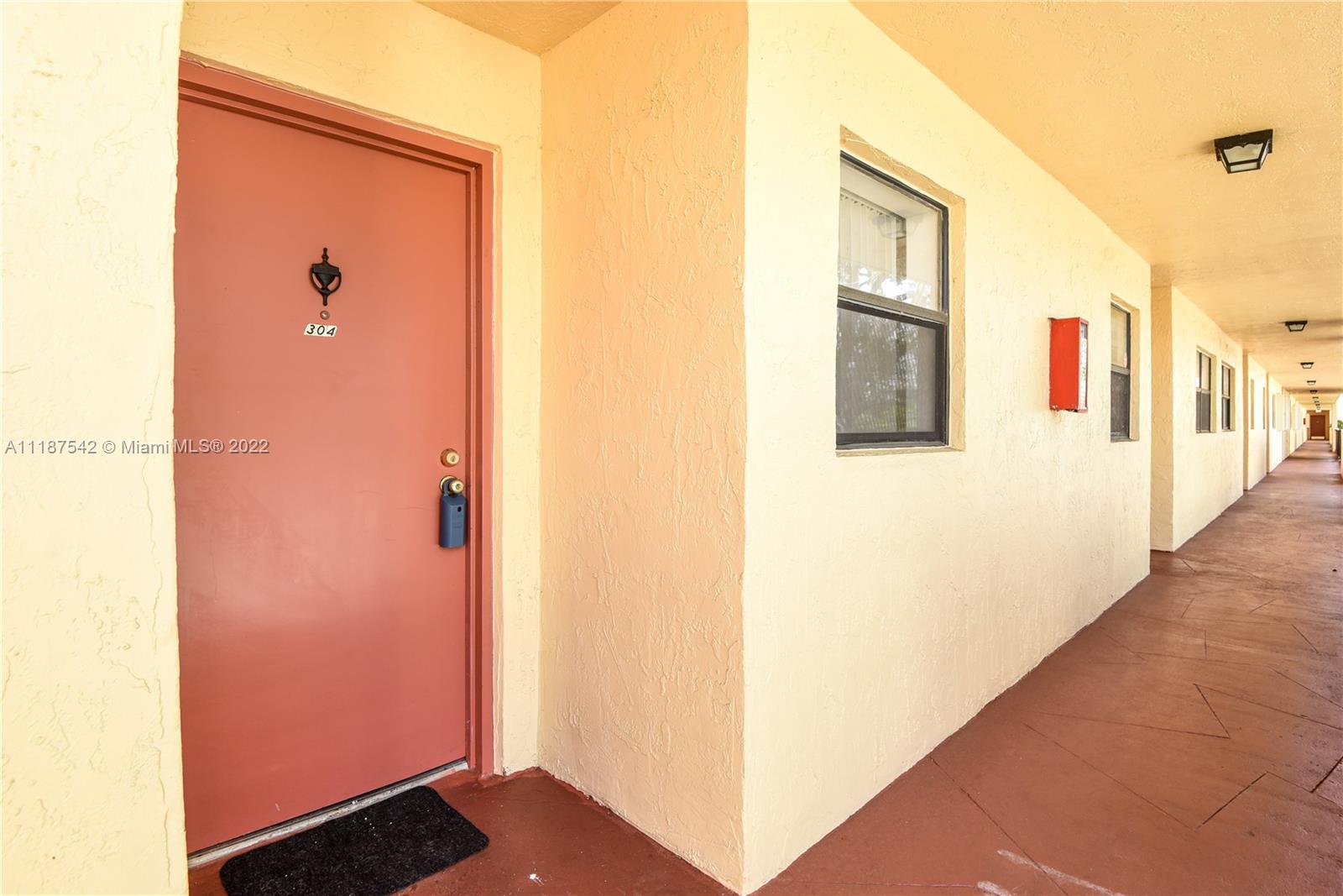 3199 Foxcroft Road, Unit 304 Miramar, FL 33025 - Photo 26 of 35 a view of a hallway with wooden floor