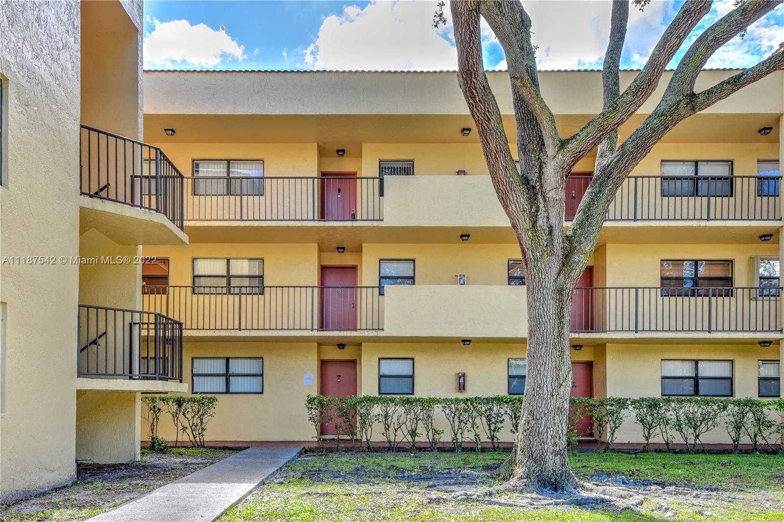 3199 Foxcroft Road, Unit 304 Miramar, FL 33025 - Photo 28 of 35 a front view of a building with a garden