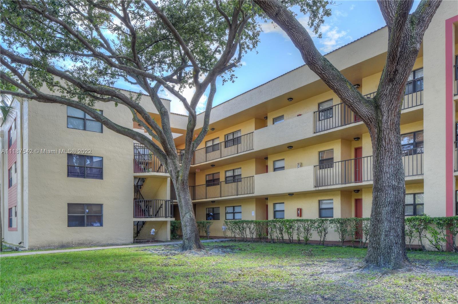 3199 Foxcroft Road, Unit 304 Miramar, FL 33025 - Photo 29 of 35 front view of building with a yard