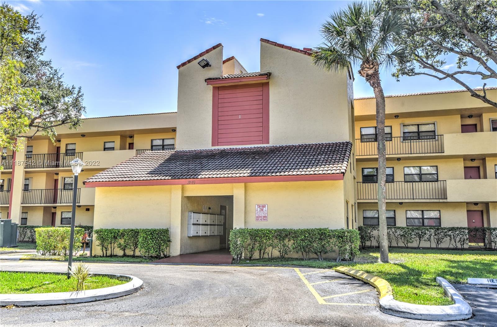 3199 Foxcroft Road, Unit 304 Miramar, FL 33025 - Photo 30 of 35 a front view of a building with garden and plants