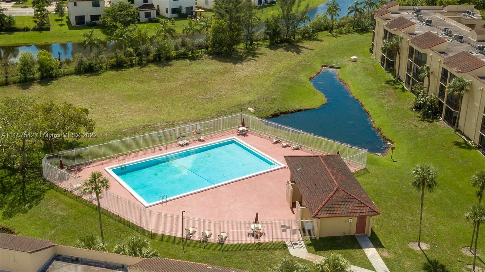 3199 Foxcroft Road, Unit 304 Miramar, FL 33025 - Photo 32 of 35 an aerial view of a house with a yard lake lake view and trees