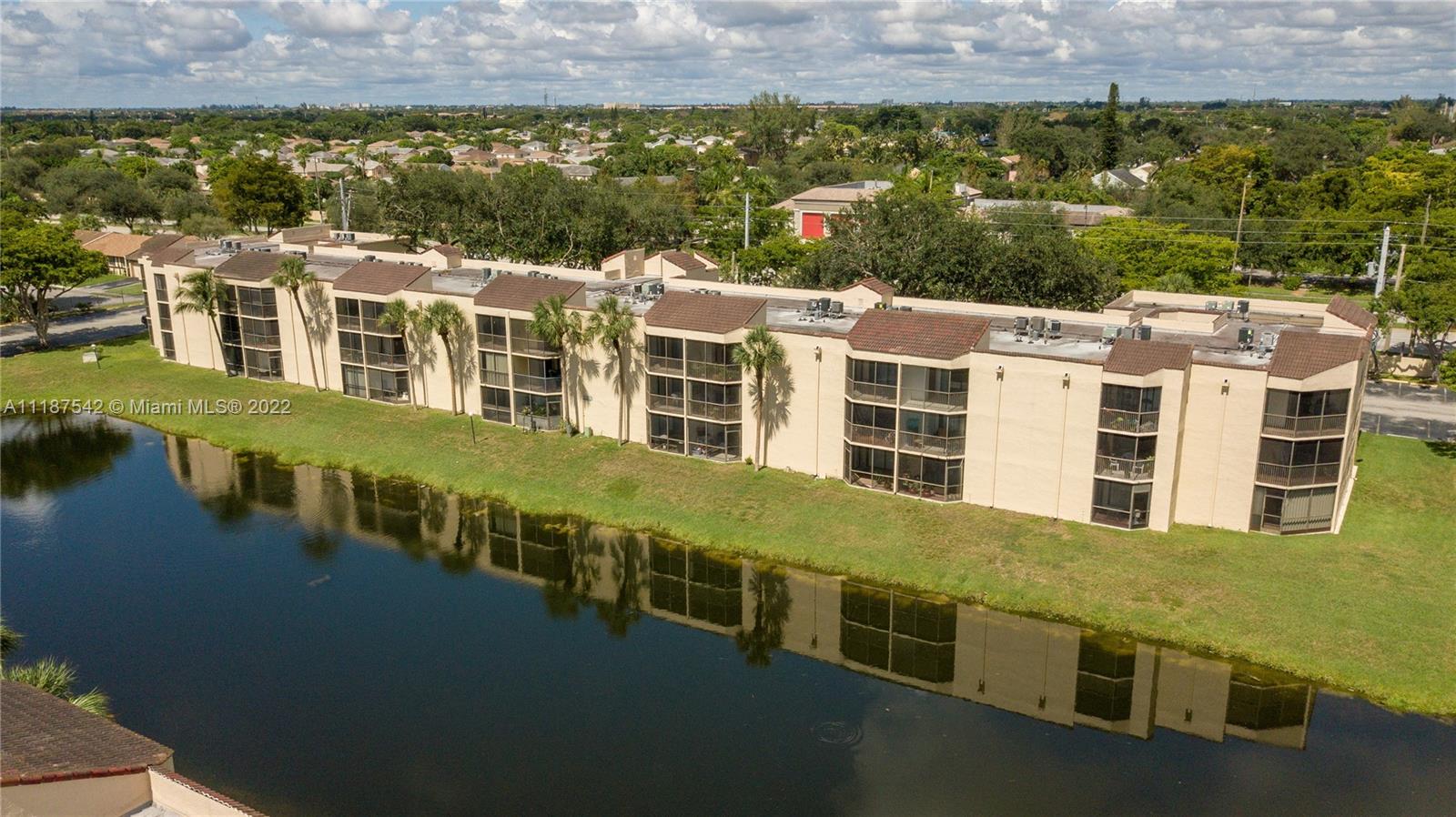 3199 Foxcroft Road, Unit 304 Miramar, FL 33025 - Photo 35 of 35 a view of a large building with a lot of windows and trees