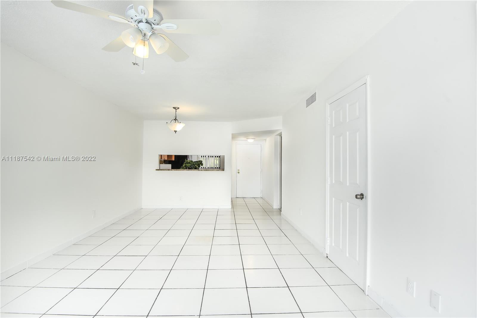 3199 Foxcroft Road, Unit 304 Miramar, FL 33025 - Photo 4 of 35 a view of an empty room and chandelier fan