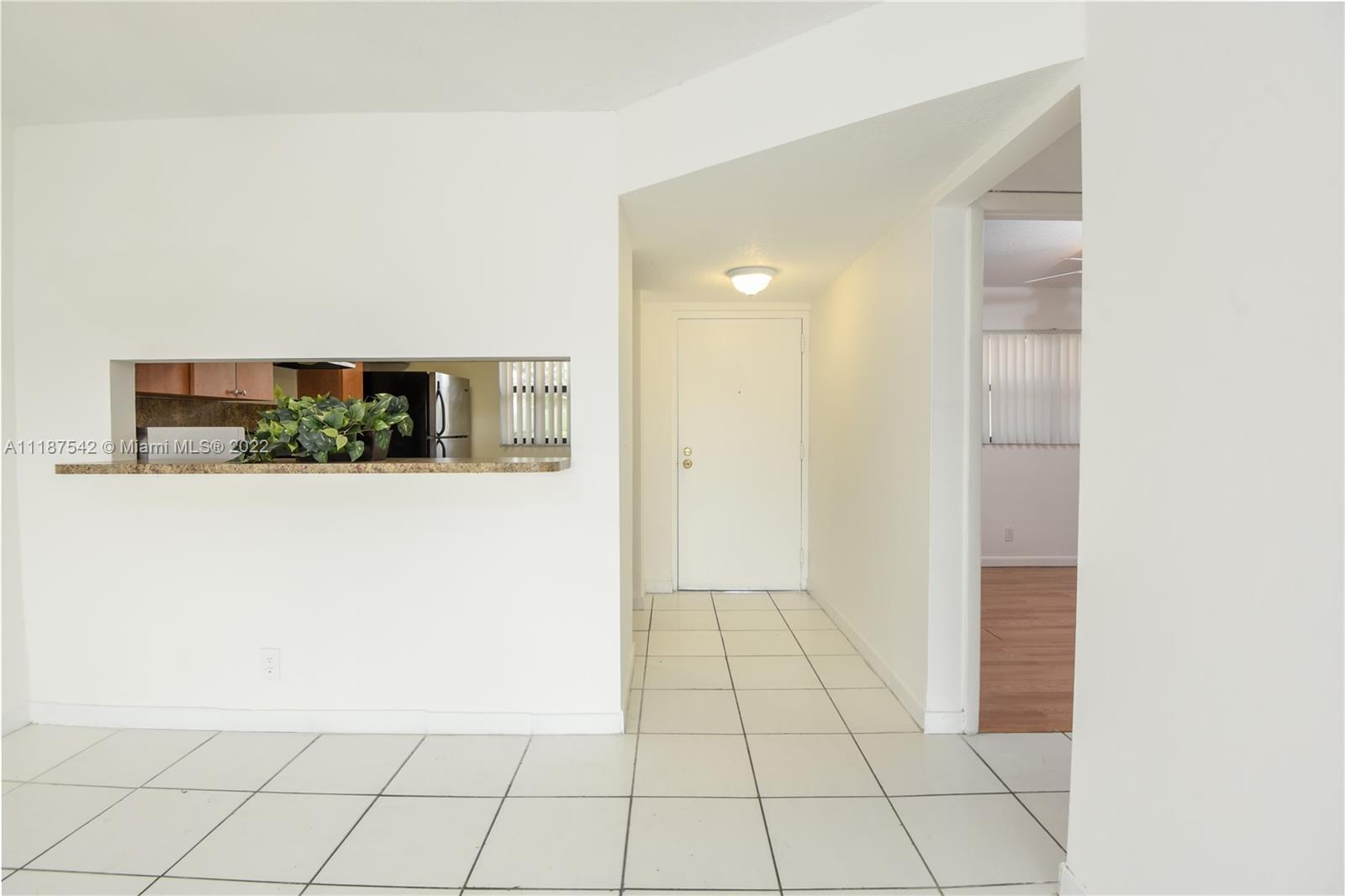 3199 Foxcroft Road, Unit 304 Miramar, FL 33025 - Photo 7 of 35 a view of a kitchen space with cabinets