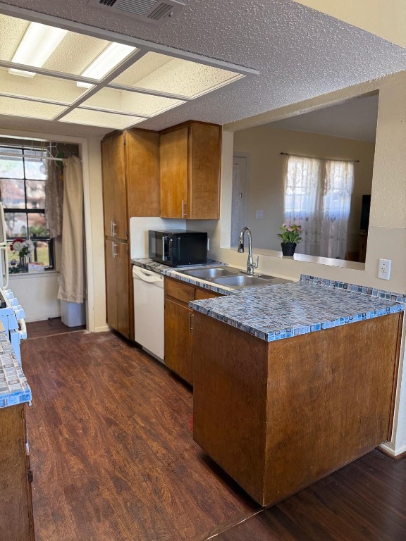 16023 Stoneham Circle Pflugerville, TX 78660 - Photo 6 of 13 a kitchen with kitchen island granite countertop wooden cabinets a refrigerator and a sink