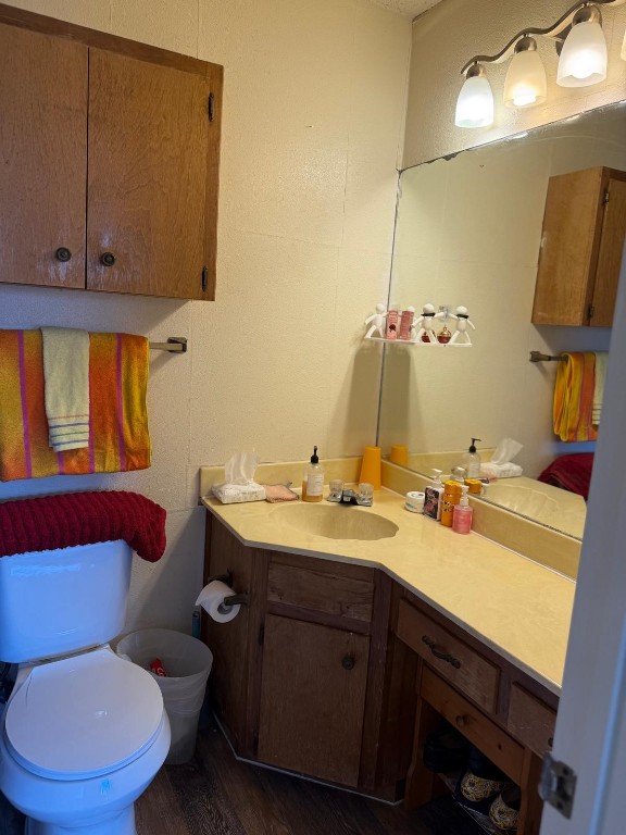 16023 Stoneham Circle Pflugerville, TX 78660 - Photo 10 of 13 a bathroom with a granite countertop toilet sink and mirror