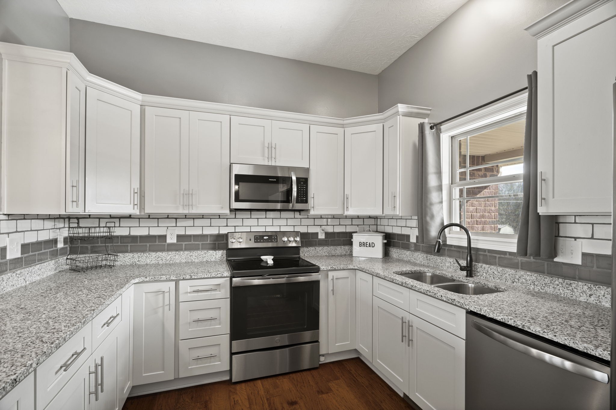 8930 New Chapel Road Springfield, TN 37172 - Photo 17 of 57 a kitchen with stainless steel appliances granite countertop a sink and stove top oven