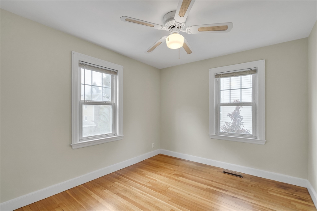 15 Sunset Road Cambridge, MA 02138 - Photo 14 of 26 a view of an empty room with wooden floor and a window