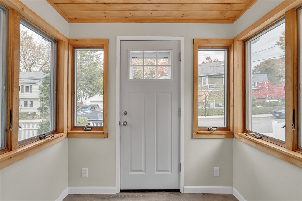 15 Sunset Road Cambridge, MA 02138 - Photo 3 of 26 a view of an empty room with wooden floor and a window