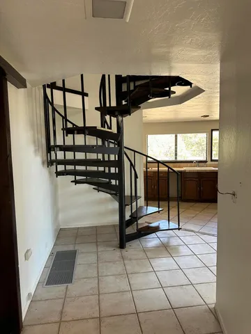 a view of a big room with wooden floor and windows