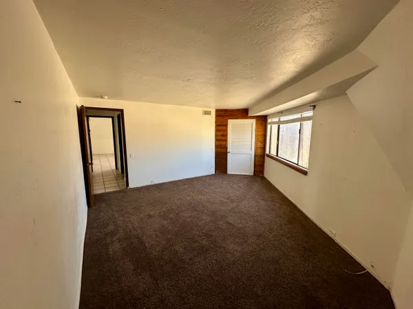 a view of room with hallway and stairs