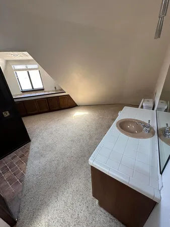 an empty room with a windows and fireplace