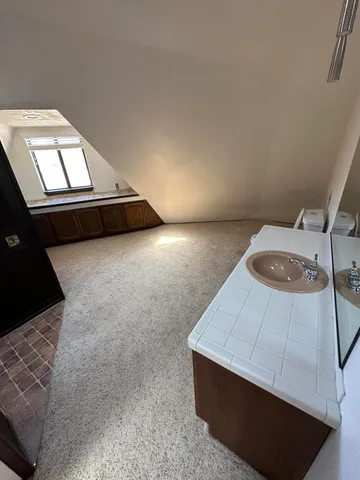 an empty room with a windows and fireplace