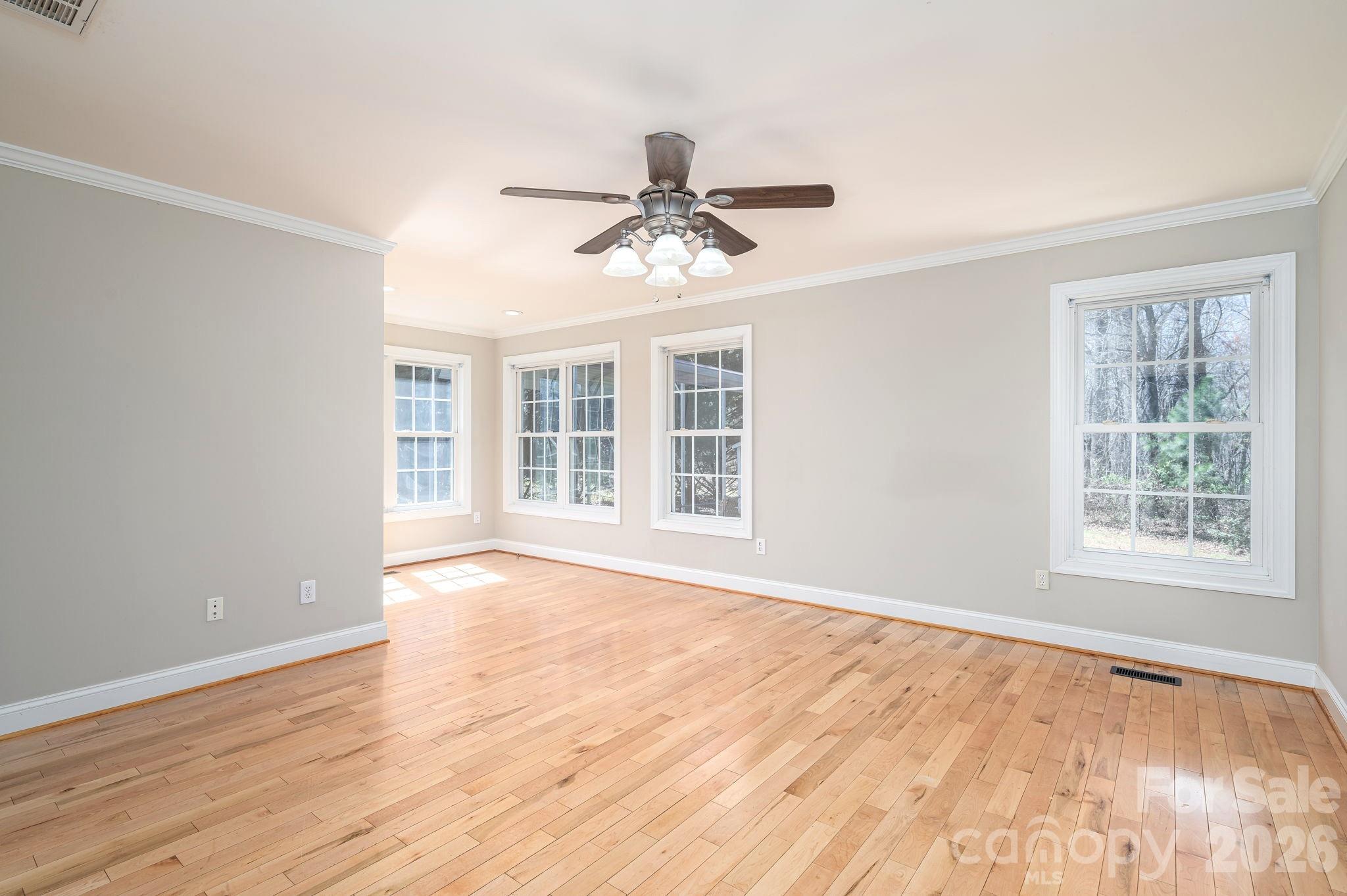 515 Highway 161 Clover, SC 29710 - Photo 12 of 30 a view of an empty room with wooden floor and a window
