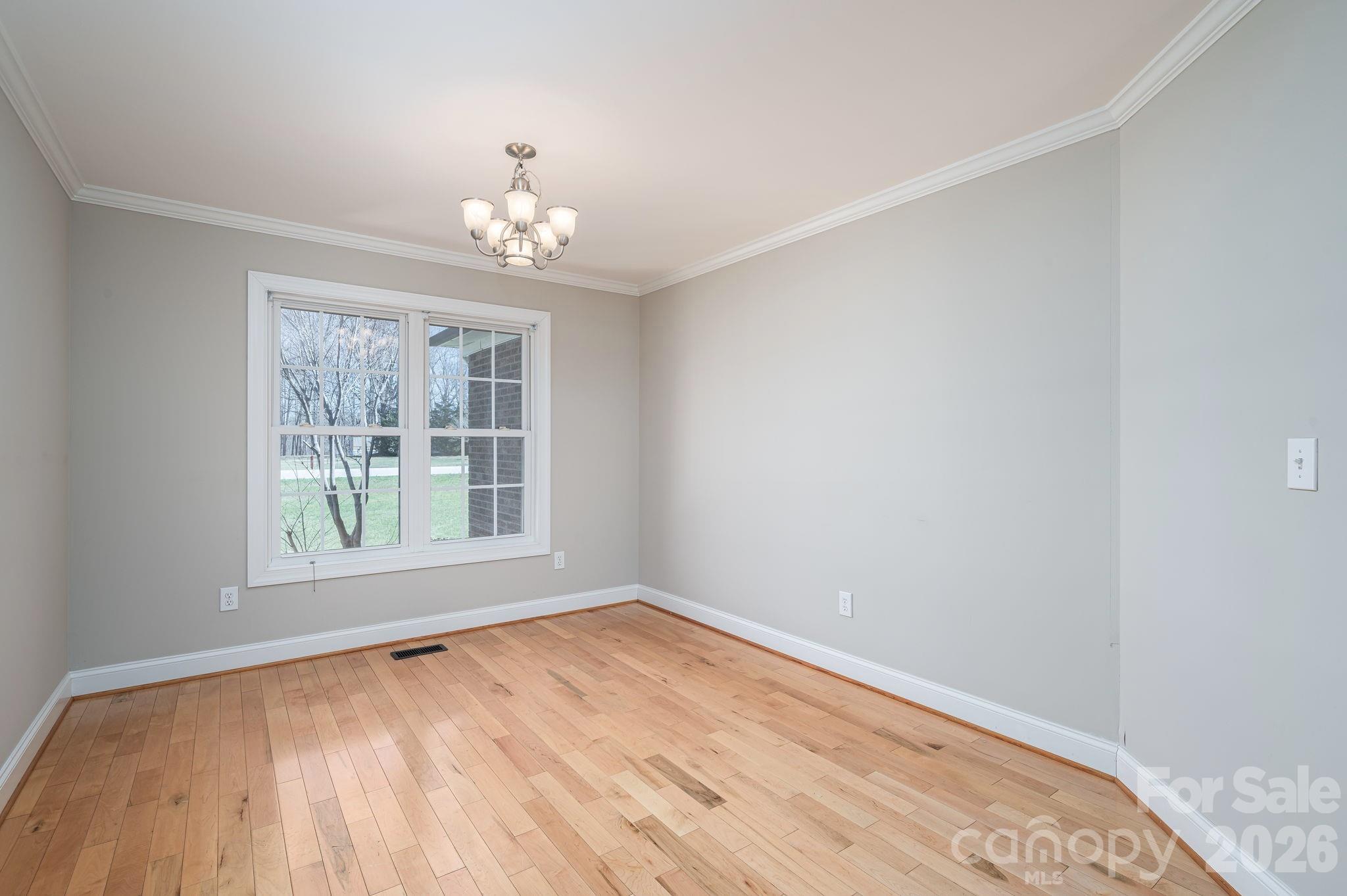515 Highway 161 Clover, SC 29710 - Photo 7 of 30 a view of an empty room with wooden floor and a window