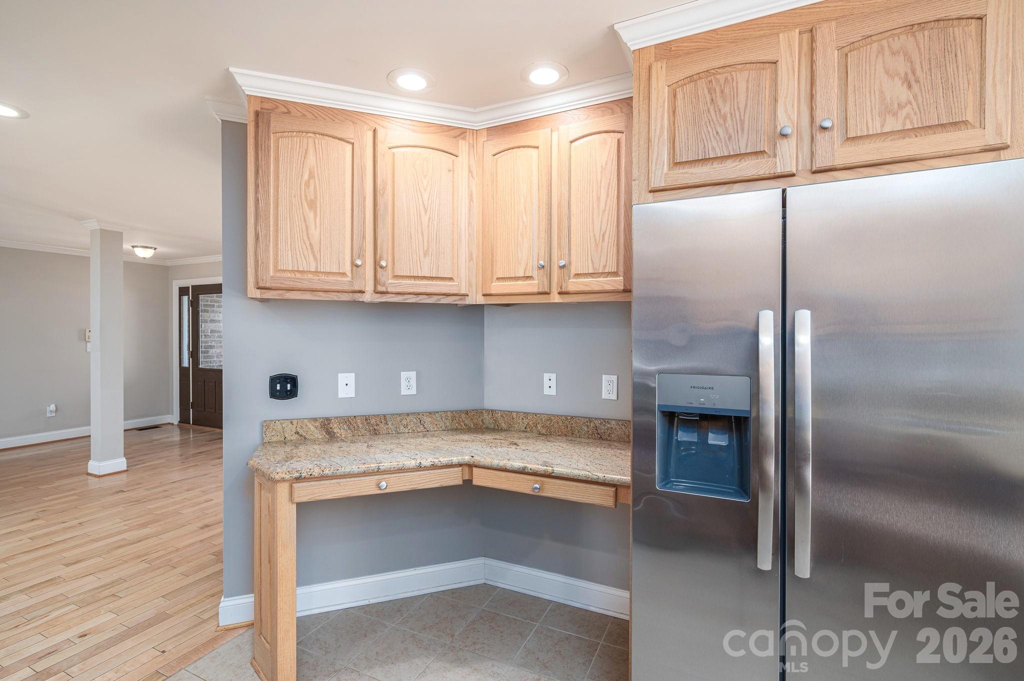 515 Highway 161 Clover, SC 29710 - Photo 9 of 30 a kitchen with granite countertop a refrigerator a stove and a sink with wooden cabinets