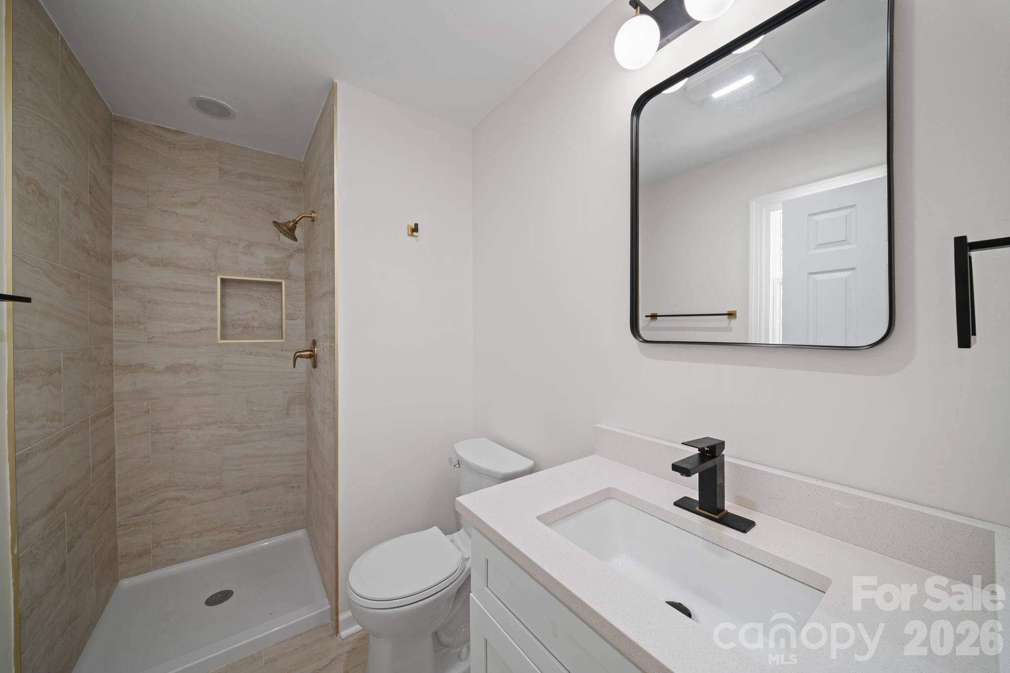 1263 See Off Mountain Road Brevard, NC 28712 - Photo 12 of 21 a bathroom with a sink a toilet and shower