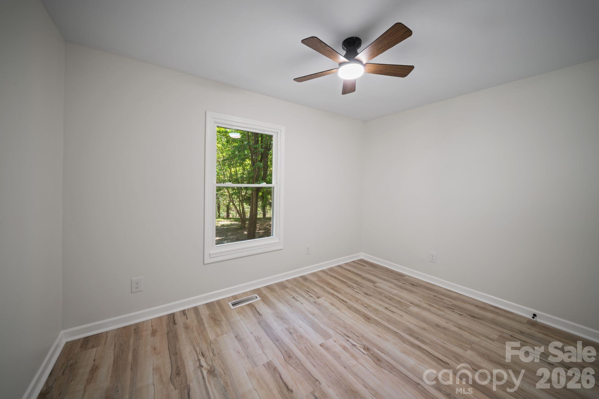 1263 See Off Mountain Road Brevard, NC 28712 - Photo 13 of 21 an empty room with a window and a ceiling fan