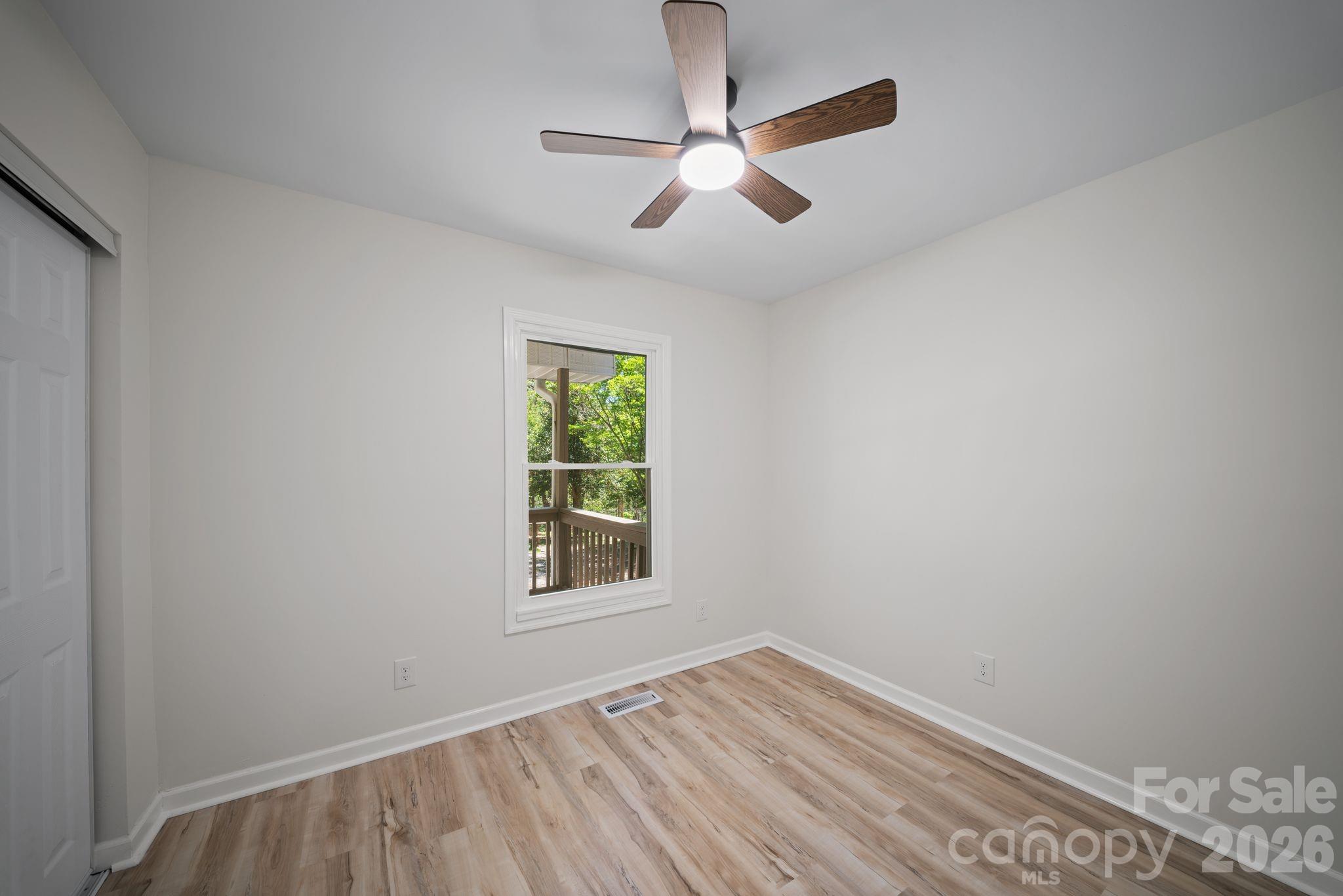 1263 See Off Mountain Road Brevard, NC 28712 - Photo 15 of 21 an empty room with a window and ceiling fan