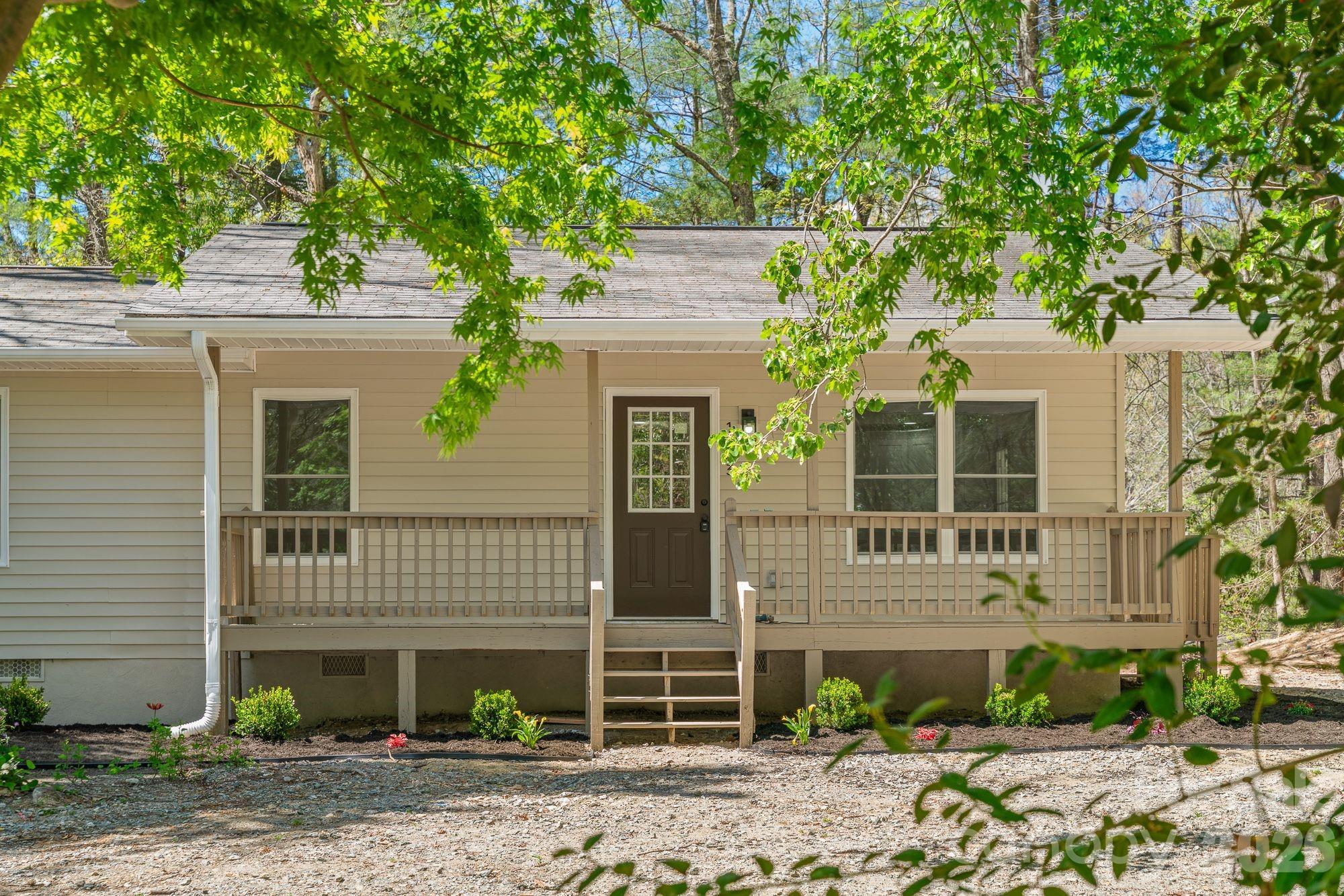 1263 See Off Mountain Road Brevard, NC 28712 - Photo 2 of 21 a front view of a house with garden