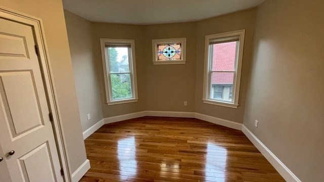 15 Dix Street, Unit 2 Boston, MA 02122 - Photo 11 of 14 a view of an empty room with wooden floor and a window