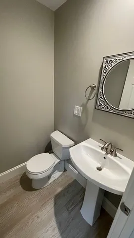 a white toilet sitting next to a bathroom sink
