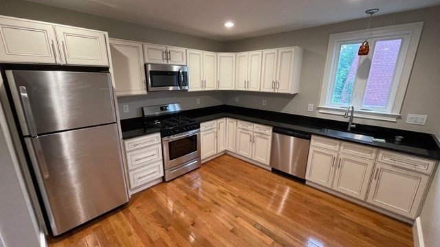 15 Dix Street, Unit 2 Boston, MA 02122 - Photo 5 of 14 a kitchen with granite countertop a refrigerator sink and microwave
