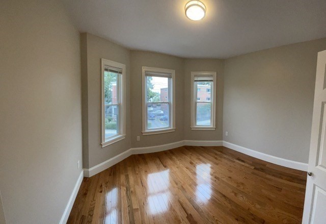 15 Dix Street, Unit 2 Boston, MA 02122 - Photo 7 of 14 a view of an empty room with wooden floor and a window