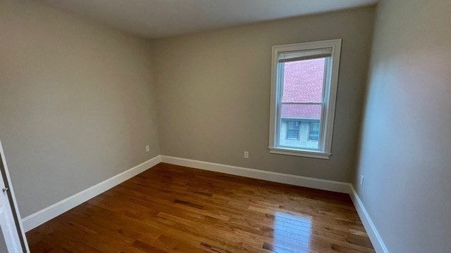 15 Dix Street, Unit 2 Boston, MA 02122 - Photo 8 of 14 an empty room with wooden floor and windows