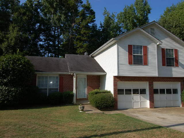 5861 Giles Road Lithonia, GA 30058 - Photo 1 of 1 a front view of a house with garden